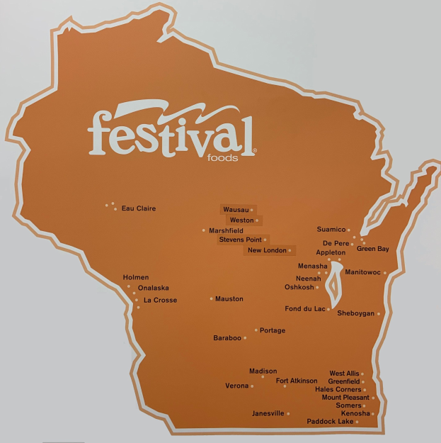 Ein leuchtendes Plakat einer Wisconsin-Karte voller verschiedener Früchte, Gemüse und Snacks mit der Aufschrift "Festival Foods".