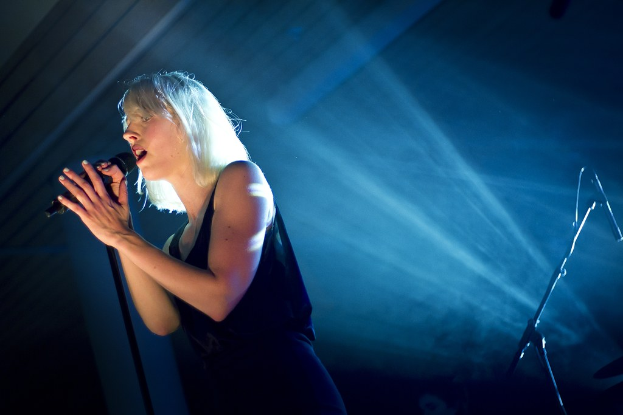 Eine Frau, die in ein Mikrofon singt.